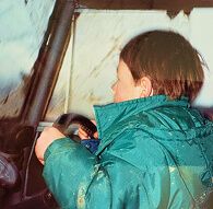 Young Dan Hinton behind the wheel of an old Land Rover